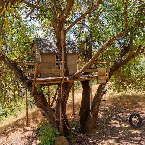 Let little ones lord over you from the wooden treehouse