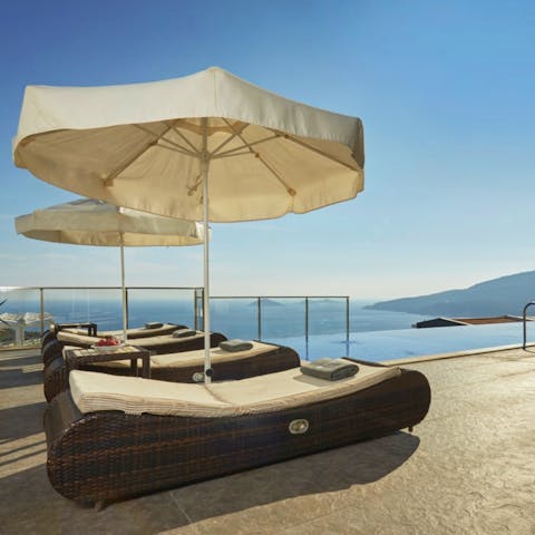 Recline on a lounger with incredible views across the Aegean Sea
