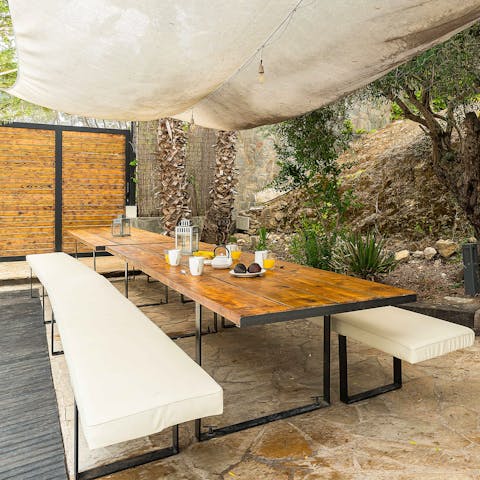Dine alfresco on the long, wooden table