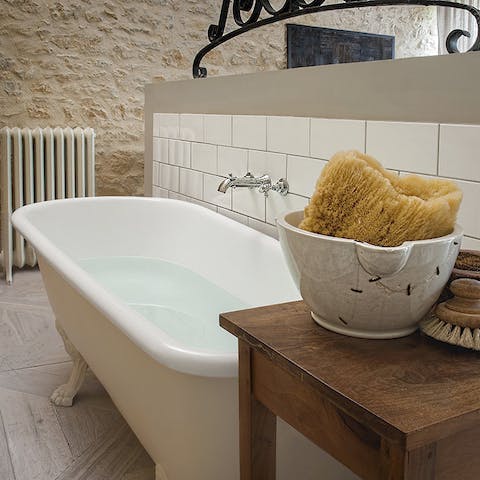 Unwind in the elegant free-standing bathtub