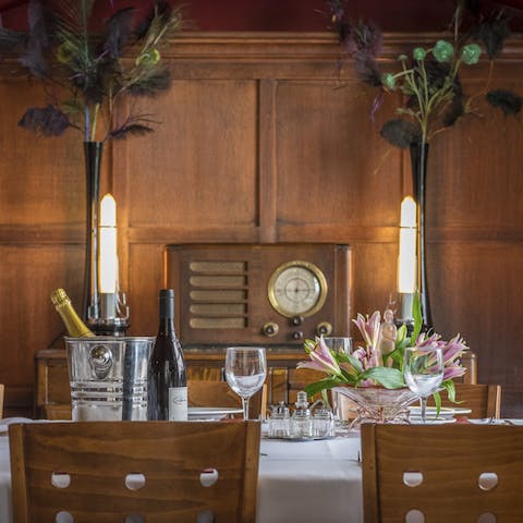 Dress up for a dinner party in the regal dining room featuring wooden paneled walls