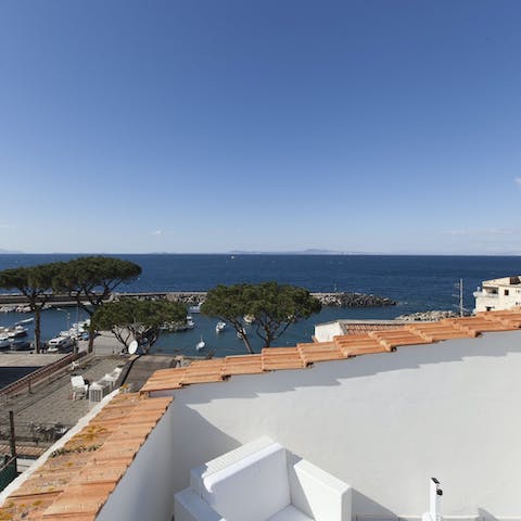 Gaze out over the marina towards the island of Ischia from your private terrace