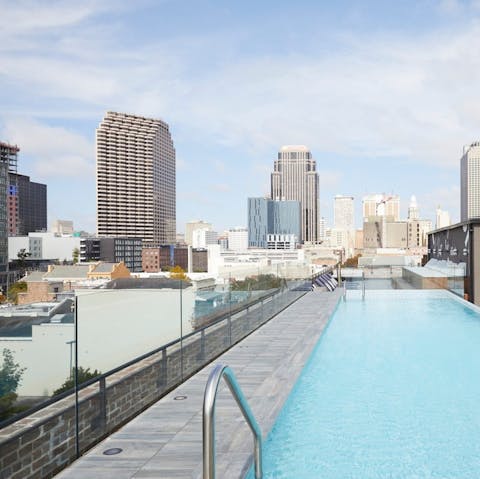 Take a dip in the rooftop pool and enjoy the stunning cityscape