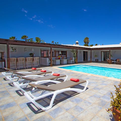 Relax and read a book on one of the comfy sun loungers