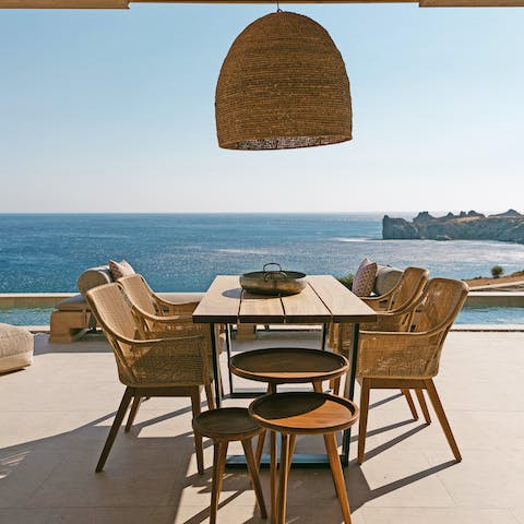 Enjoy a Greek meze and the seascape at the dining table on your terrace
