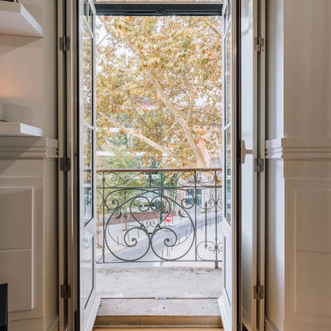 Open the living room's French doors and step out onto the private balcony