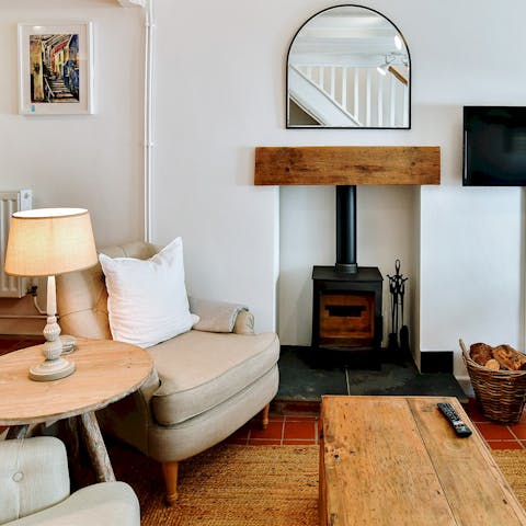 Cosy up by the wood burner fireplace on chilly winter evenings