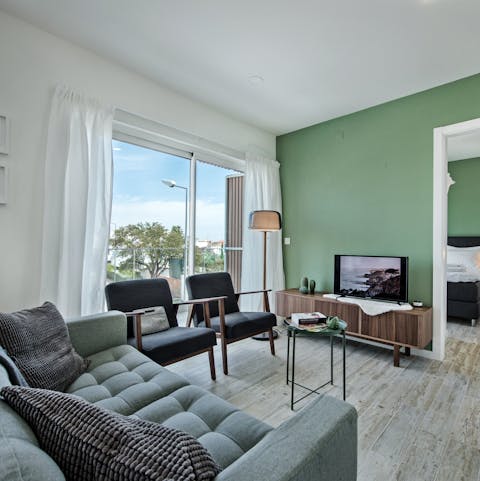 Relax in the stylish living room with its floor-to-ceiling windows