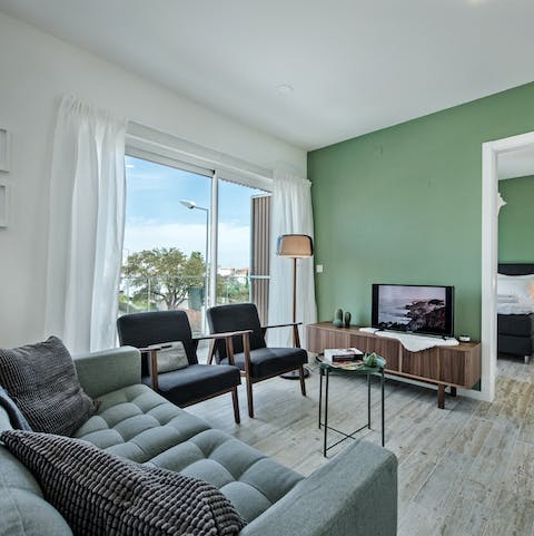 Relax in the stylish living room with its floor-to-ceiling windows
