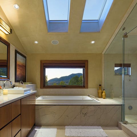 Enjoy a view of the mountain in this marble bath 