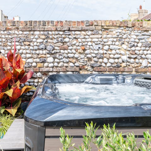 Feel the warmth of the bubbles in the dreamy outdoor hot tub