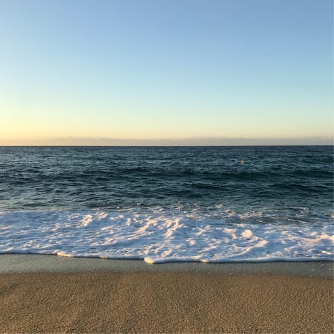 Sun yourself on sandy Calheta Beach, just over five minutes away by car