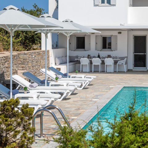 Stretch out on the sun loungers by the inviting pool