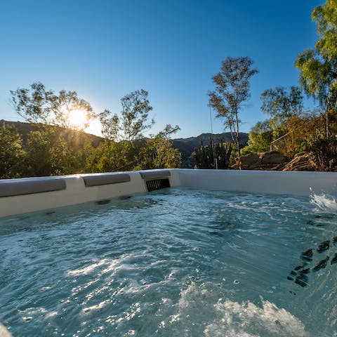 Sip a glass of fizz as you unwind in the private hot tub