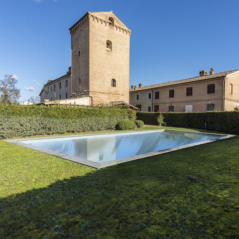 Admire views of the 13th-century tower while hopping into the seasonal pool