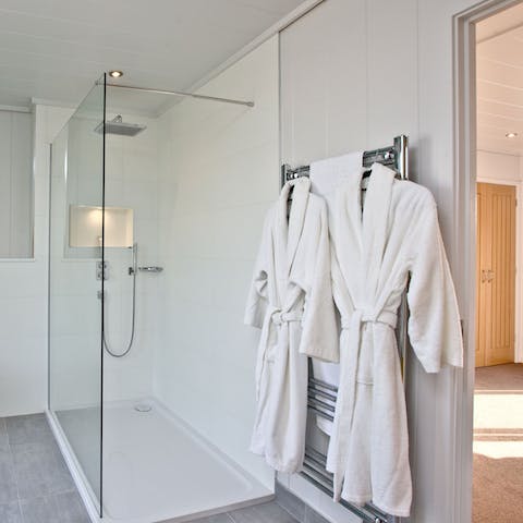Pamper yourself in the spa-like bathroom equipped with fresh robes and slippers