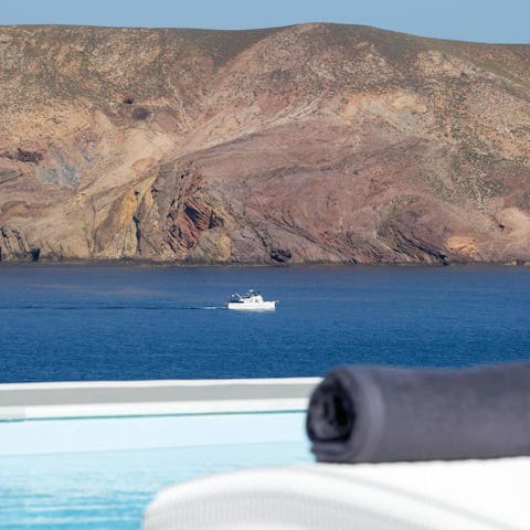 Gaze out across the water from your sun lounger – with views of the uninhabited island of Tragonisi  