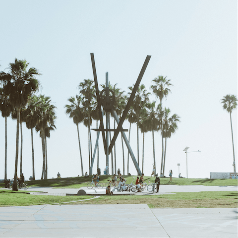 Saddle up and cycle down to the vibrant Venice boardwalk – it's under a mile away