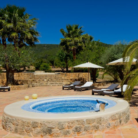 Relax in the sunken stone jacuzzi