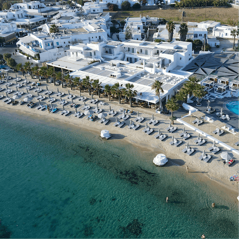 Soak up the vibrant spirit of island life from Ornos beach – a short drive away
