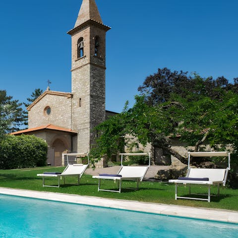Soak up the Italian sun with the imposing church tower behind you 