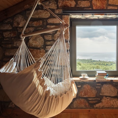 Curl up on the hanging swing with a coffee, a good book, and gorgeous views