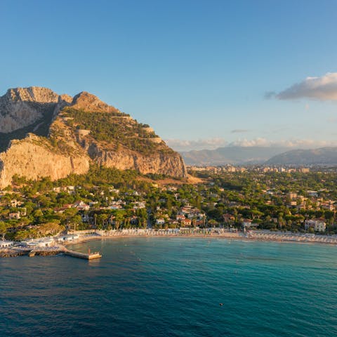 Slip into the shallow and inviting waters of Mondello Beach, a little over 11km away