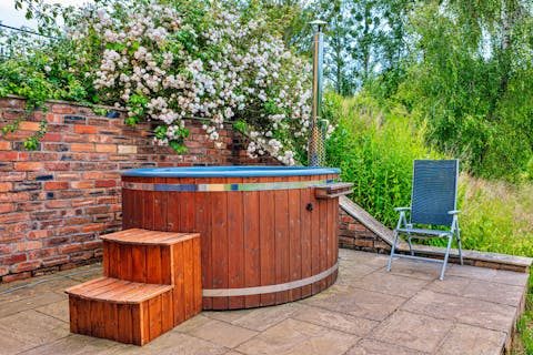 Sip wine as you relax in the wood-fired hot tub