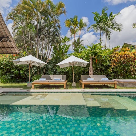 Soak up that vitamin D by the private pool under the palms