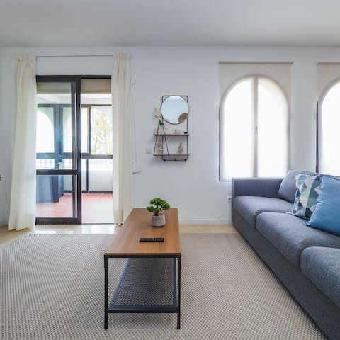 Gather on the cosy sofas and let the natural light in through the large windows