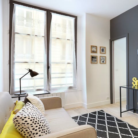 Relax in the tranquil, light-filled living space  after a long day of exploring Paris 
