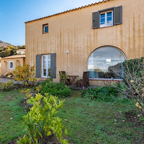 Sit outside to truly appreciate the green garden and views beyond