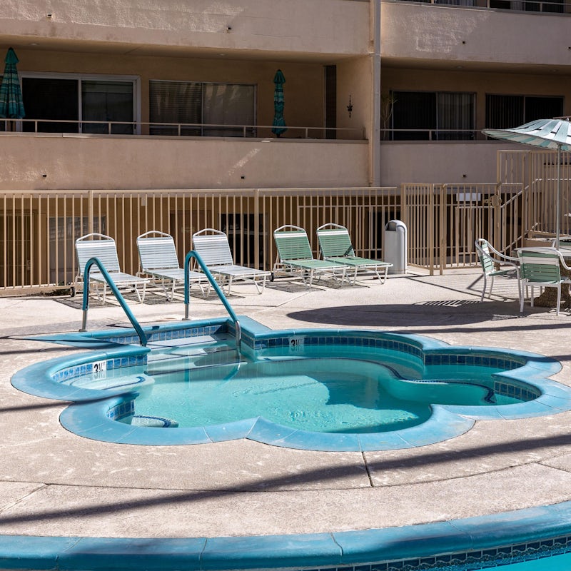 Relax on the pool deck with a book on one of the sun loungers