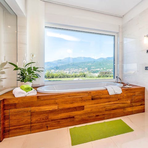 Soak away the stress in the bathtub as you gaze out over the vista