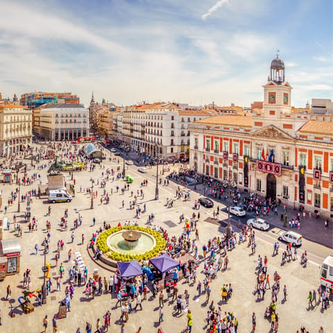 Stroll around bustling Puerta del Sol, a three-minute walk away
