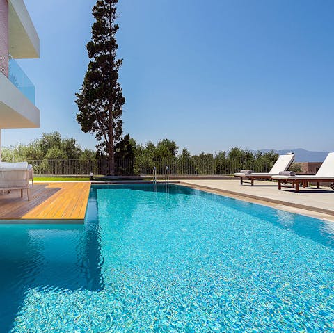 Relax and lounge in the sun by the glistening pool 