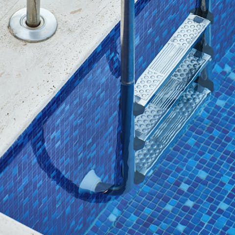 Take a refreshing dip in the sparkling swimming pool