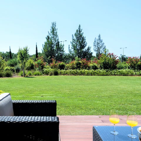 Relax on the private terrace overlooking the luscious shared gardens
