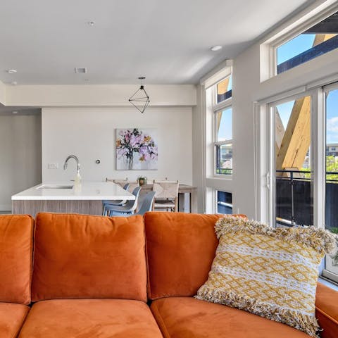 Kick back on the orange sofa with a glass of wine and a movie playing on HBO