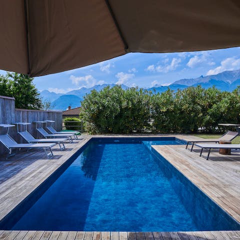 Slip into the swimming pool and admire the mountain view
