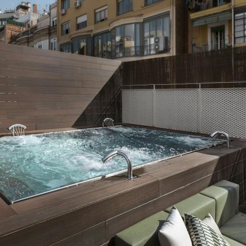 Head up to the shared rooftop deck and take a soak in the jacuzzi