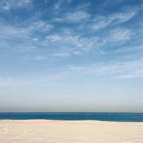 Bask in the sunshine on Jumeirah Beach, a fifteen-minute drive away