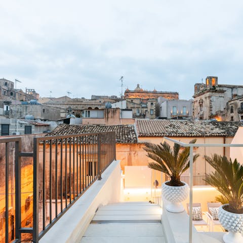 Gaze out over Sicily's rugged rooftops over a large glass of red