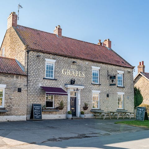 Sip crisp pints in The Grapes Inn, a minute's walk from your doorstep