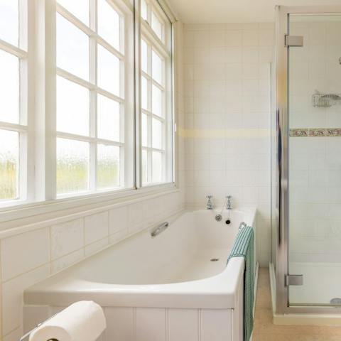 Take a soak in the home's bright, white bathroom