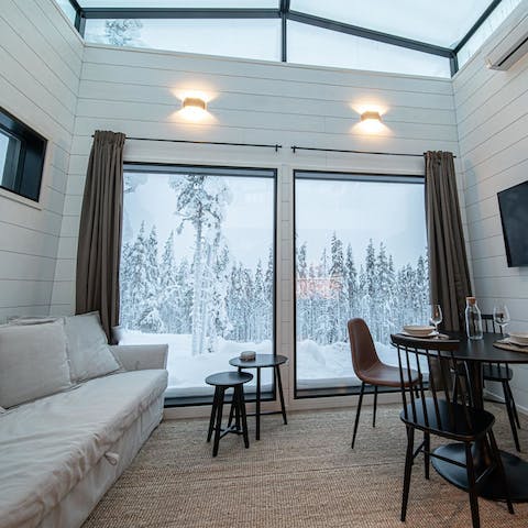 Gaze out at the snow-capped forest from picture-frame windows