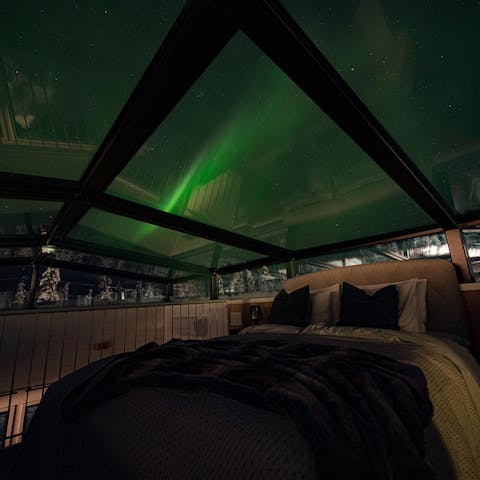 Watch the Northern Lights through the glass ceiling from the comfort of bed