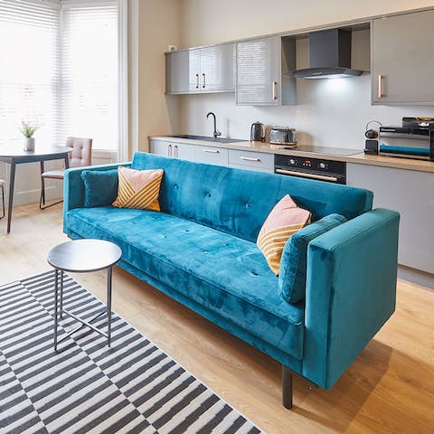 Mix a G&T and stretch out on the blue velvet sofa after a busy day