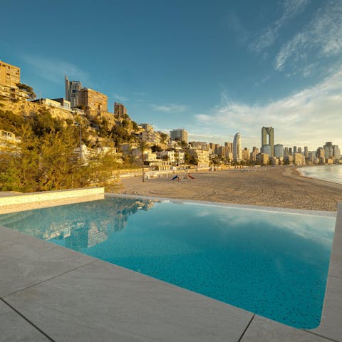 Watch the sun set over Benidorm as you float about in the private pool