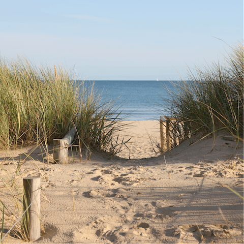 Drive six minutes to Blacklands Beach to paddle in the shallows